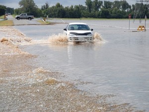 Car drives through flood water