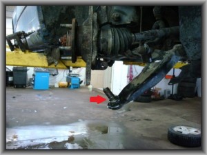 Old ball joint to be removed from control arm.